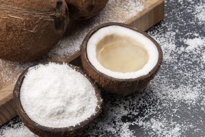 cut fresh coconut with real coconut milk on a dark background of