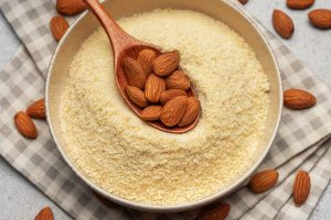Fresh almond flour in a  bowl and almonds